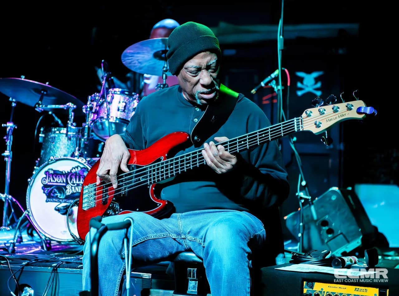Jacques Jones, seated with red bass